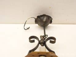 Vintage wrought iron lamp with ornate scrollwork, perfect for elegant, nostalgic decor.