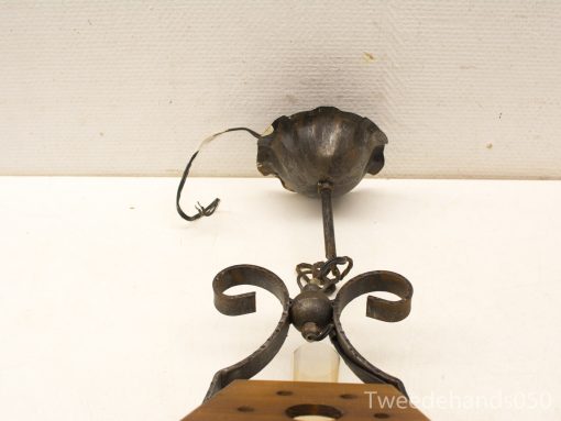 Vintage wrought iron lamp with ornate scrollwork, perfect for elegant, nostalgic decor.