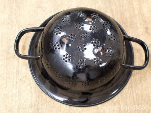Sleek black colander with handles for draining pasta and washing vegetables in style.