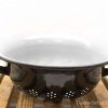 Vintage black enameled colander with white interior, perfect for draining pasta and washing vegetables.