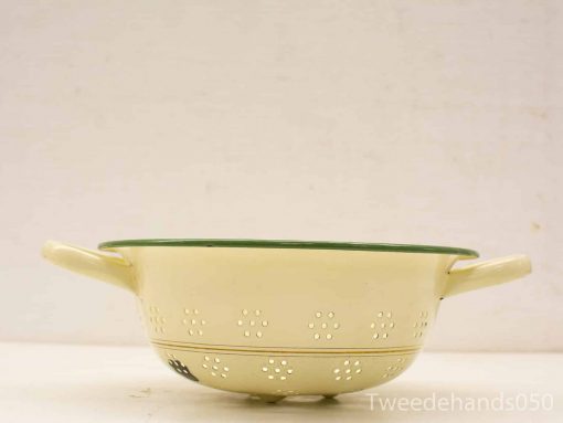 Vintage yellow enamel colander with green trim, perfect for draining pasta and vegetables.