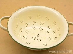 Vintage yellow enamel colander with floral pattern and green rim, perfect for kitchen use.