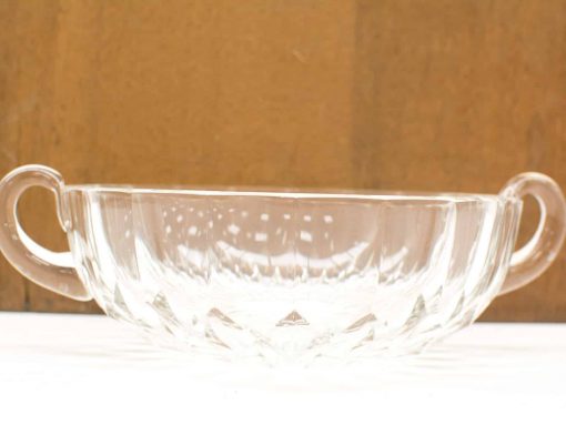 Elegant glass bowl with handles, featuring intricate design and vintage charm for stylish decor.