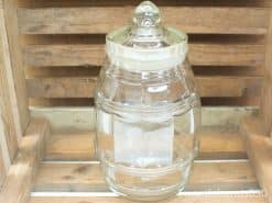Classic glass jar with domed lid, perfect for storing treats or decorative items.