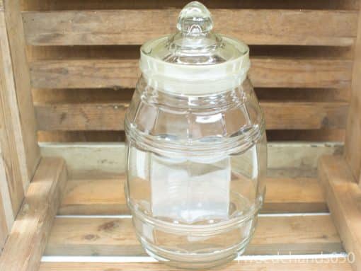 Classic glass jar with domed lid, perfect for storing treats or decorative items.