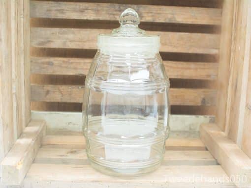 Vintage glass jar with lid for stylish storage and rustic home decor.