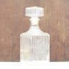Elegant glass decanter with geometric stopper, perfect for serving whiskey or fine wine.