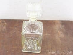 Elegant vintage glass decanter with ornate stopper, perfect for spirits or decorative display.