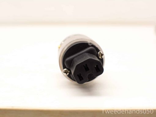Vintage C14 power plug with gold plating for durable electronic connections.