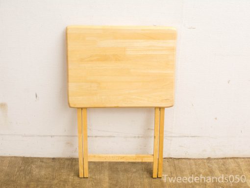 Versatile wooden folding table, perfect for small spaces and various uses in stylish interiors.