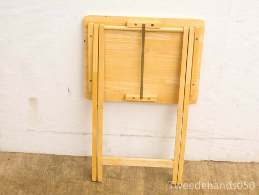 Vintage wooden folding table for versatile use in dining, crafts, or outdoor activities.
