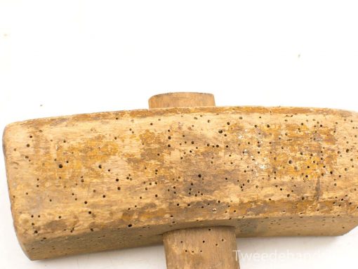 Rustic wooden perforation tool showcasing craftsmanship, wear, and a rich artisanal history.