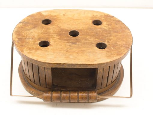 Vintage wooden container with wire handle, featuring unique holes and rustic charm for decor.