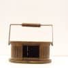 Charming vintage wooden basket with metal handle and open slot for versatile storage.