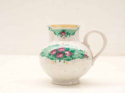 Vintage ceramic jug with hand-painted roses and gold accents for charming decor.