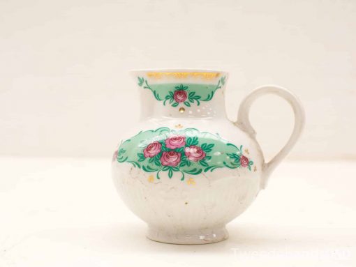 Vintage ceramic jug with hand-painted roses and gold accents for charming decor.