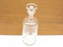 Elegant glass carafe with vintage charm, perfect for serving drinks or as a decorative piece.