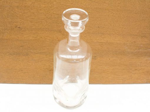Elegant glass carafe with vintage charm, perfect for serving drinks or as a decorative piece.