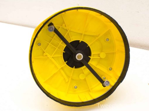 Vibrant yellow wheel underside with black traction, designed for stability and durability in use.