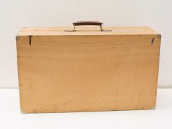 Vintage wooden suitcase with history, leather handle, and metal corner protectors.
