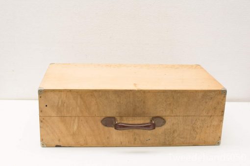 Vintage wooden storage box with metal accents and leather handle, perfect for retro enthusiasts.