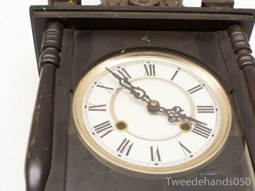Antique wooden clock with Roman numerals, glass cover, and elegant craftsmanship - timeless decor piece.