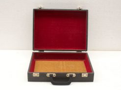 Timeless vintage briefcase with red interior, perfect for documents and stylish organization.