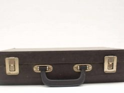 Vintage black suitcase with charm and history, perfect for travel or stylish decor.