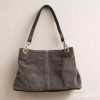 Elegant gray suede handbag with black leather handle, perfect for casual or semi-formal occasions.