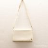 Elegant cream handbag with adjustable strap, perfect for any occasion. Minimalist design and versatile style.