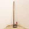 Vintage metal caliper with red handle, ideal for precise measurements in any workspace.