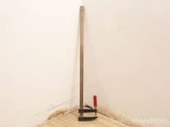 Vintage metal caliper with red handle, ideal for precise measurements in any workspace.