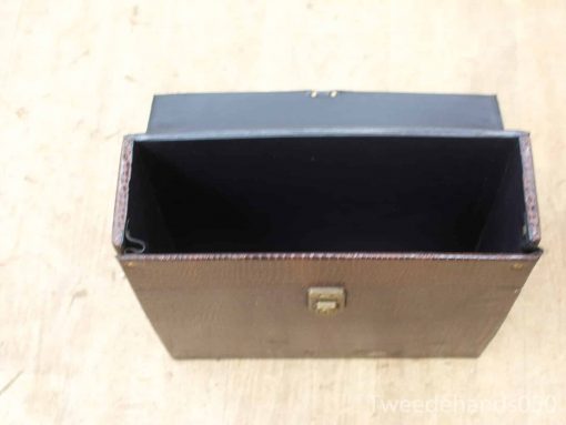 Antique leather storage box with black lining, elegant craftsmanship and vintage charm.