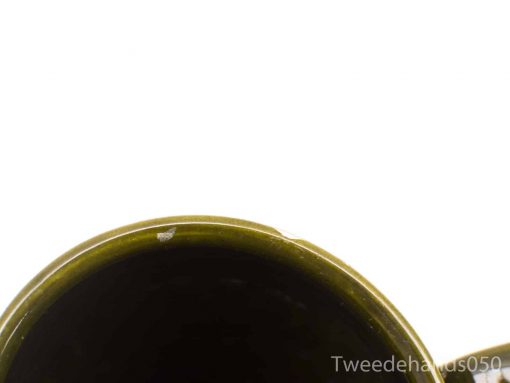 Elegant dark green glossy mug with unique imperfections, perfect for daily use or decoration.