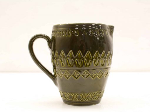 Handcrafted dark green ceramic jug with intricate triangular and diamond patterns for home decor.