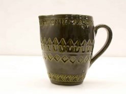 Elegant dark green ceramic mug with unique patterns, perfect for everyday use or as a collectable.