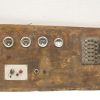 Vintage wooden control panel with gauges and switches, showcasing industrial history and craftsmanship.