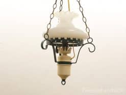 Vintage hanging lamp with frosted glass shade and ornate metal details, perfect for nostalgic interiors.