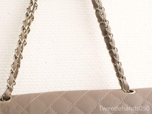 Elegant taupe handbag with quilted design and stylish chain strap for versatile occasions.