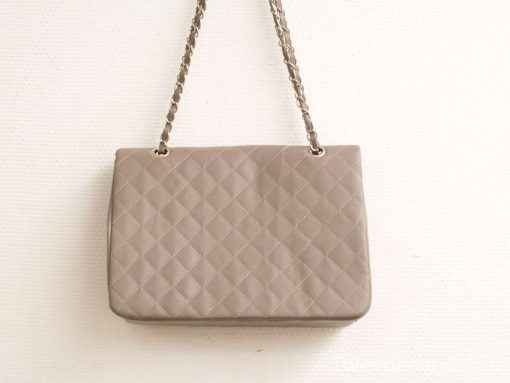 Elegant beige handbag with quilted design and stylish chain handles for every occasion.