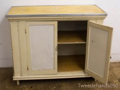 Charming vintage beige cabinet with doors and shelves, perfect for stylish storage and decor.