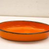 Vibrant orange oval dish with glossy finish and sleek black rim, perfect for serving or decor.