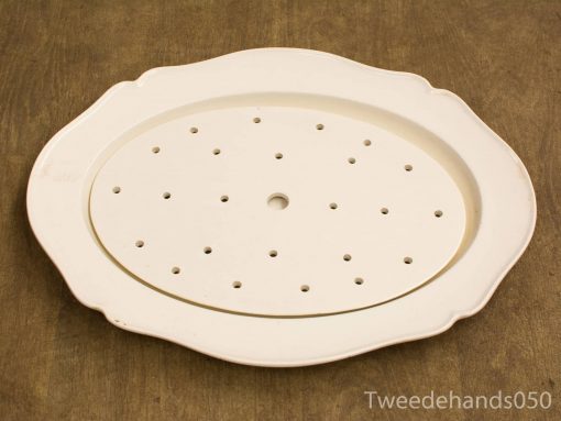 Elegant vintage oval ceramic serving platter with scalloped edges and functional drainage holes.