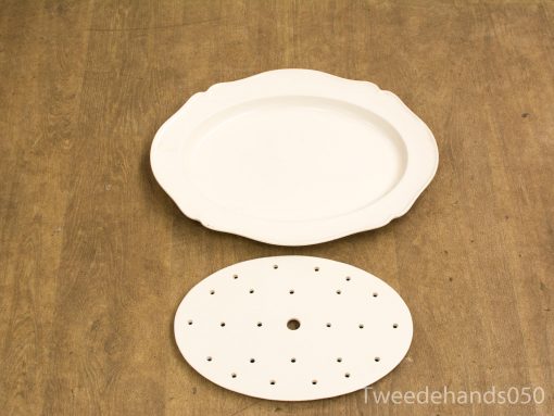 Elegant vintage oval platter with steamer insert for stylish dining presentations.