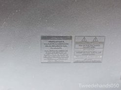 Philips TV Model 20768 safety label: bilingual warnings on voltage and electric shock hazards.