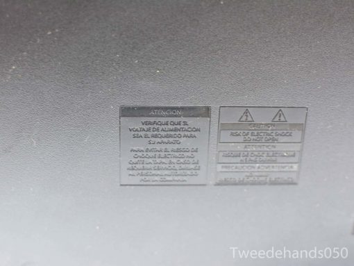 Philips TV Model 20768 safety label: bilingual warnings on voltage and electric shock hazards.