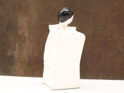 Stylized black and white ceramic dancer figure, embodying elegance and abstract artistry.