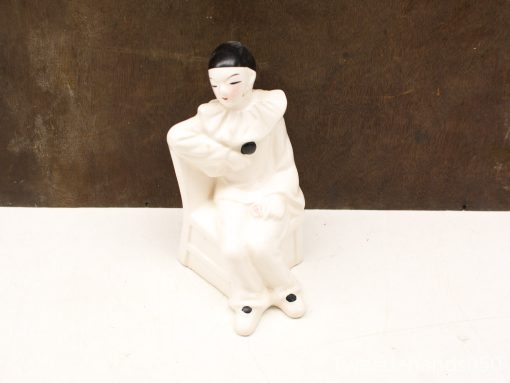 Vintage porcelain pierrot clown figurine with elegant pose and wistful expression, ideal for collectors.