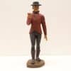 Vintage figurine of a man in a red jacket with a white collar and black pants.