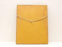 Vintage golden-yellow frame with playful bow, perfect for art or photos.
